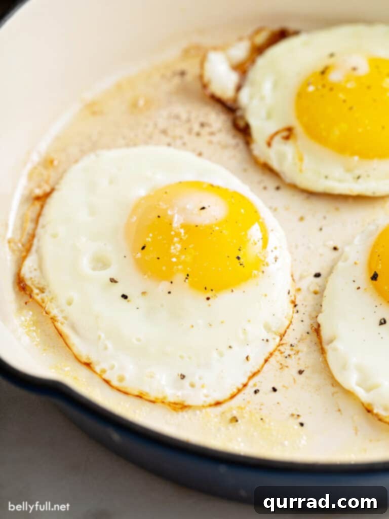 Perfect sunny side up fried egg with a runny yolk in a pan