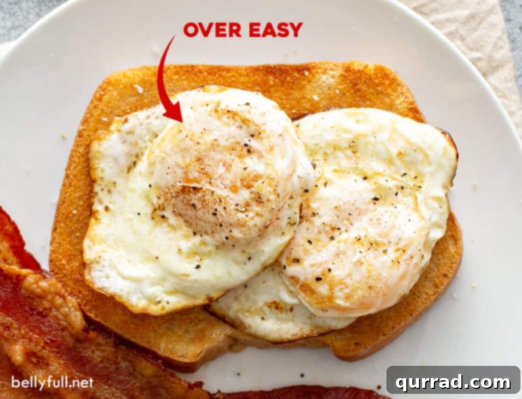Two over easy fried eggs served on a slice of toast