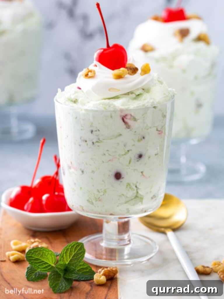 Pistachio Cloud Salad 2 Watergate Salad in a parfait glass, garnished with a cherry.