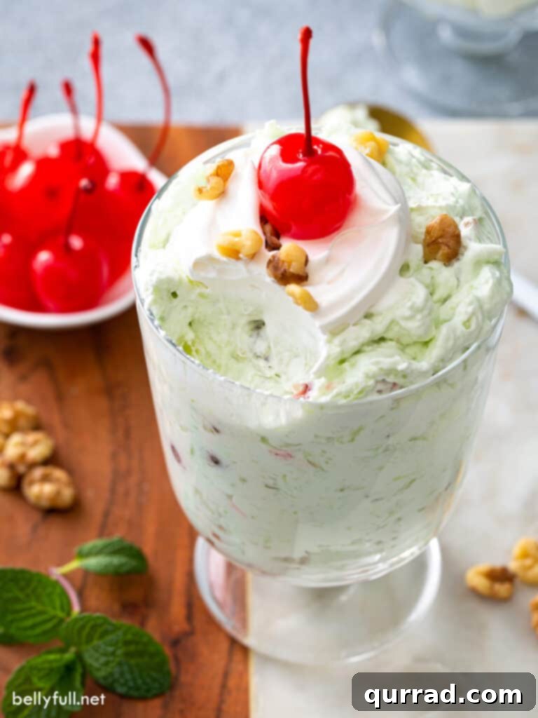 Pistachio Cloud Salad 4 Watergate Salad (Pistachio Fluff) served in a parfait glass with a spoon, showing its creamy texture.