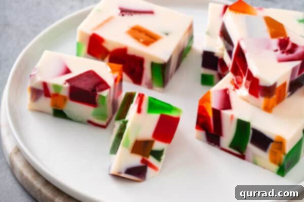 Slices of Broken Glass Jello arranged neatly on a serving plate.
