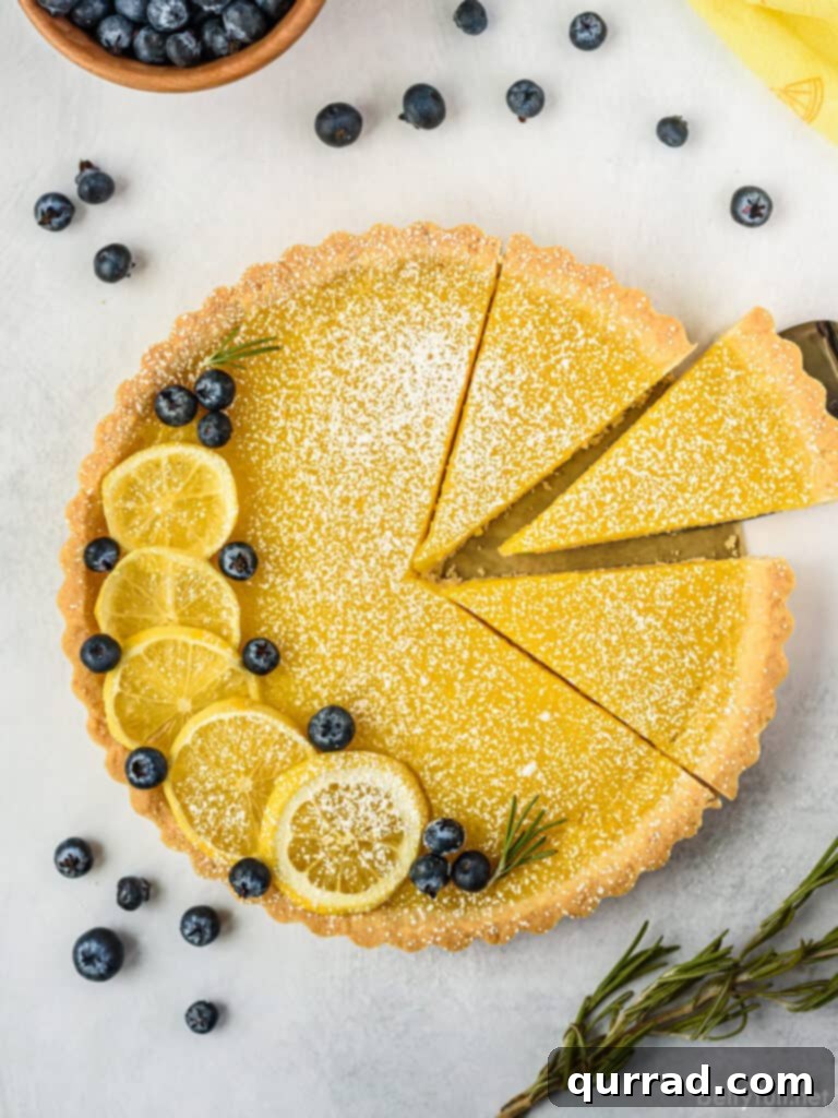 An overhead shot of a whole lemon tart with three perfectly cut slices, revealing the golden curd and crumbly crust.