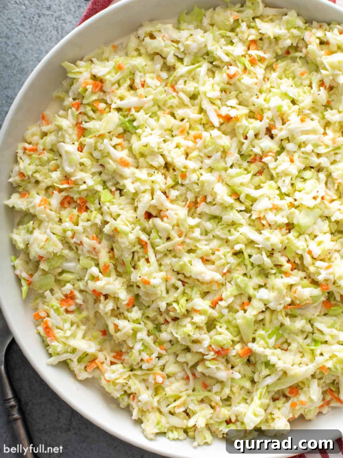 Homemade KFC Coleslaw Secret Revealed 5 close up overhead KFC coleslaw in white serving bowl, showcasing its fine texture and creamy dressing