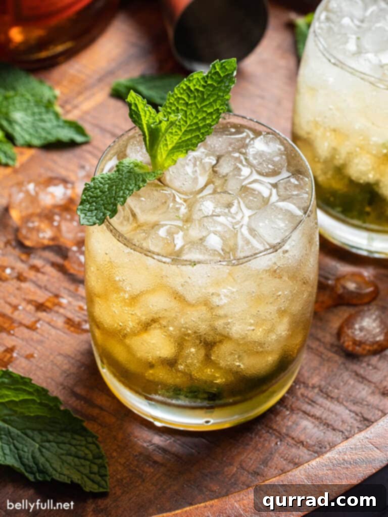 Southern Minted Sip 2 Classic Mint Julep cocktail served in a frosty julep cup on a wooden board with fresh mint