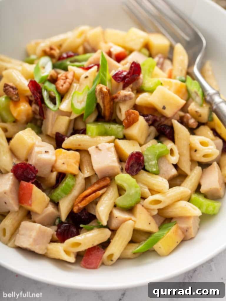 Crisp Apple Turkey Pasta Salad 6 A perfectly portioned serving of Turkey Apple Pasta Salad in a small white bowl, ready to be enjoyed, showcasing the blend of ingredients.