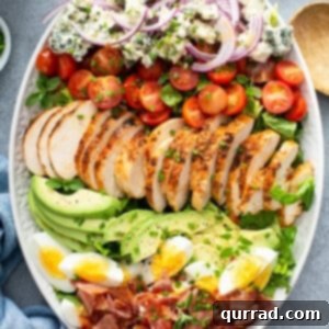 overhead view of a vibrant Cobb Salad on a white serving platter