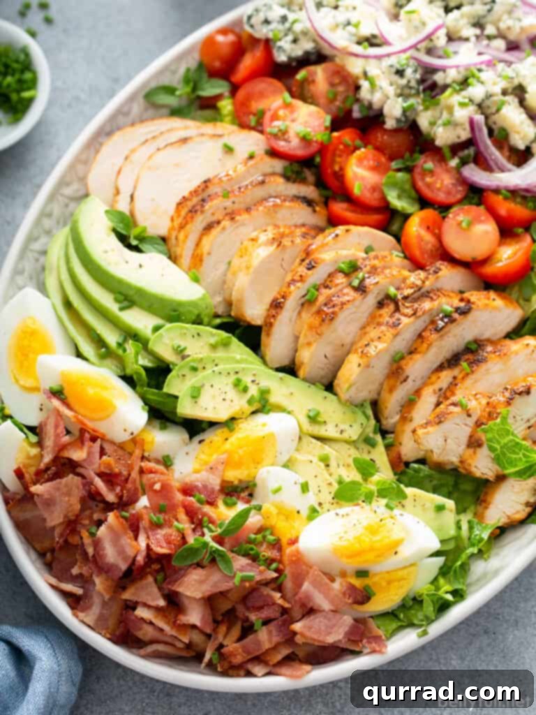 Legendary Cobb Salad 6 Finished Cobb Salad on a serving platter, drizzled with dressing and garnished.