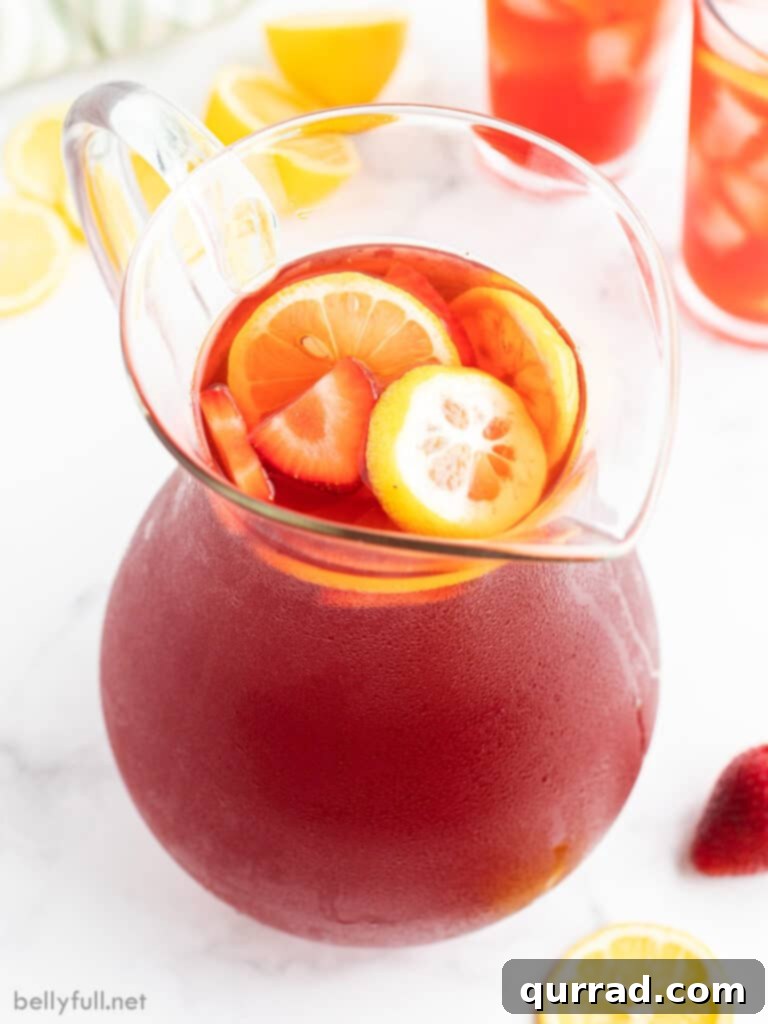 Strawberry Nectar Brew 3 strawberry tea in glass pitcher with lemon slices