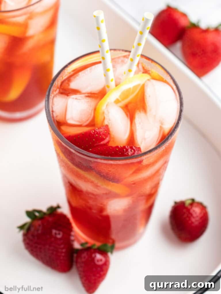 Strawberry Nectar Brew 4 tall glass of strawberry sweet tea with ice, strawberries slices, and a straw