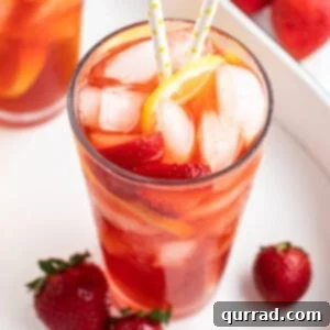 Strawberry Nectar Brew 5 tall glass of strawberry sweet tea with ice, strawberries slices, and a straw