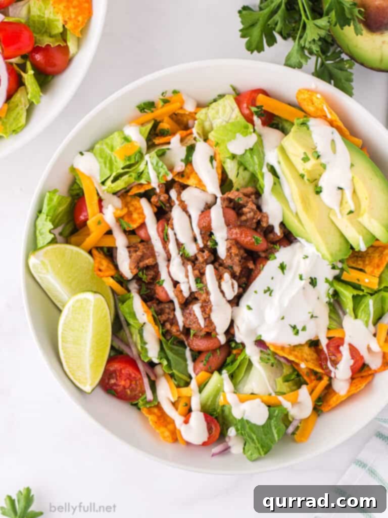Mexican salad with ground beef drizzled with Ranch dressing