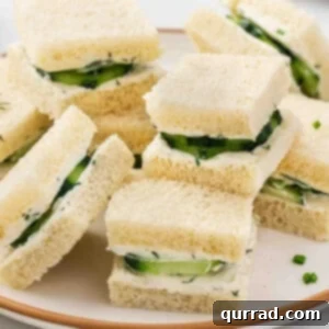 Stacked cucumber tea sandwiches on a plate