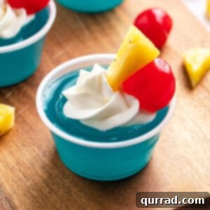 Electric Blue Hawaiian Shots 6 Blue Hawaiian jello shot garnished with pineapple and a maraschino cherry