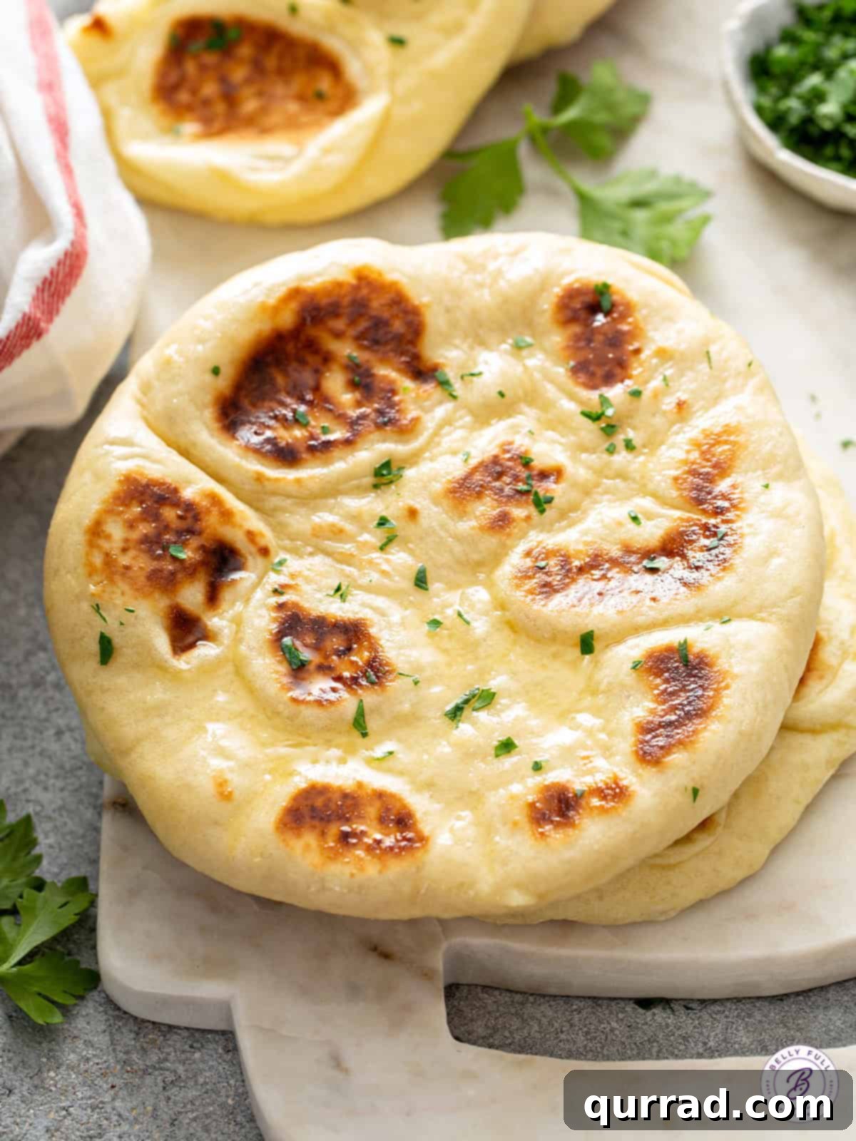 Freshly Baked Garlic Butter Naan Warm homemade naan with garlic, butter, and parsley, ready to be enjoyed