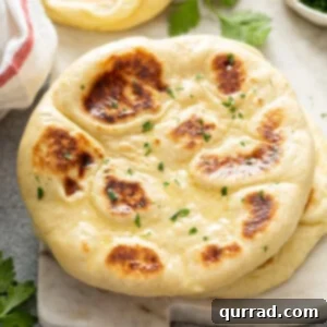 Finished Garlic Naan Bread Warm homemade naan with garlic, butter, and parsley, perfectly garnished