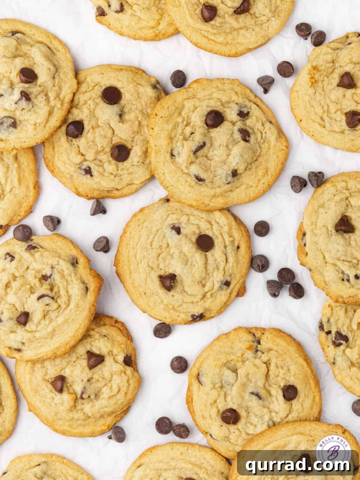 Soft and Chewy Chocolate Chip Pudding Cookies 3 A close-up shot of several freshly baked chocolate chip pudding cookies cooling on parchment paper, showcasing their soft texture and rich chocolate.