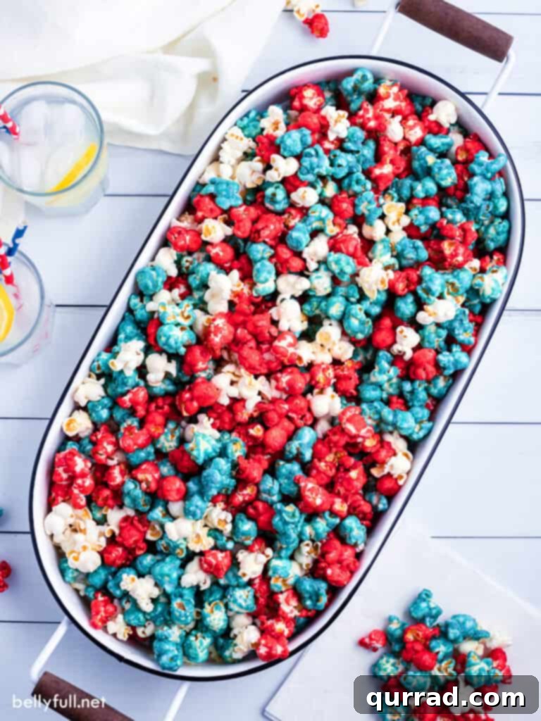 All American Caramel Corn 2 Vibrant red, white, and blue caramel corn in an oval serving bucket, ready for festive celebrations.
