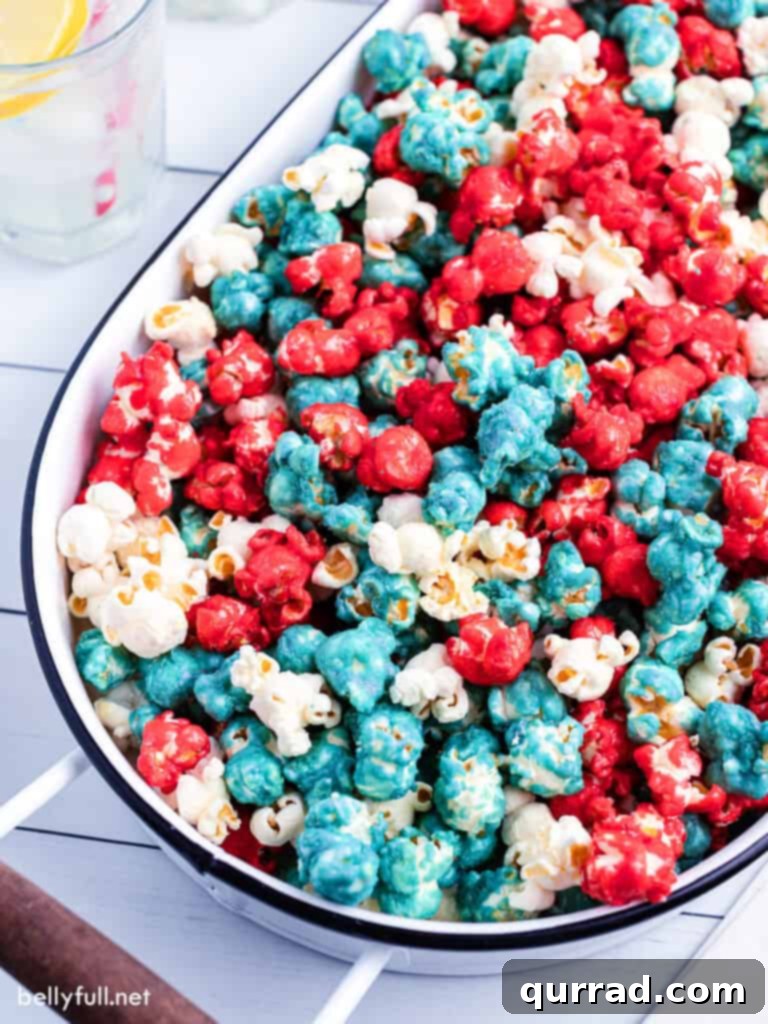 All American Caramel Corn 3 Close-up of festive red, white, and blue caramel corn in an oval serving bucket, highlighting its delightful texture.