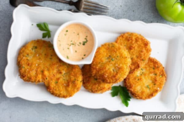 fried green tomatoes on serving dish with dipping sauce
