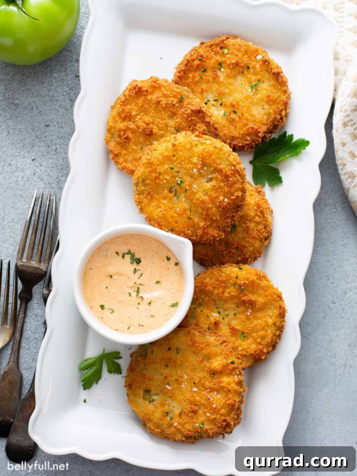 overhead shot of fried green tomatoes on serving plate with remoulade sauce