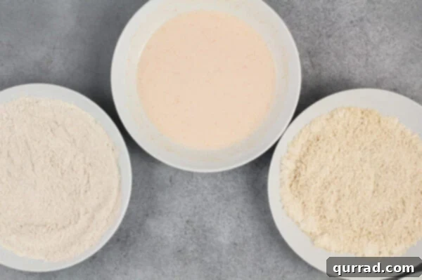 breading station with 3 bowls of breadcrumbs, flour, and milk