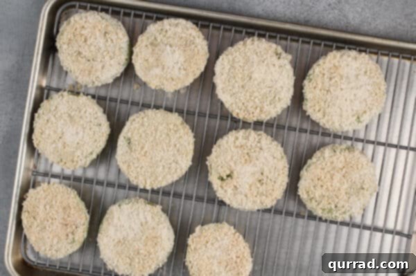 breaded sliced green tomatoes on wire rack