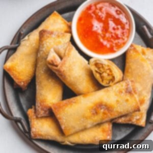 overhead shrimp egg rolls on serving platter with sweet chili sauce