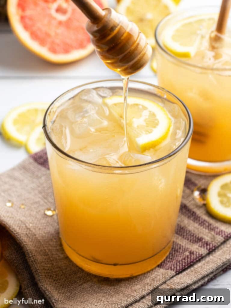 Honey-Kissed Gin Sour 4 A beautifully presented Bee's Knees cocktail, garnished with a honey drizzler, emphasizing its delightful sweetness and sophisticated appeal.