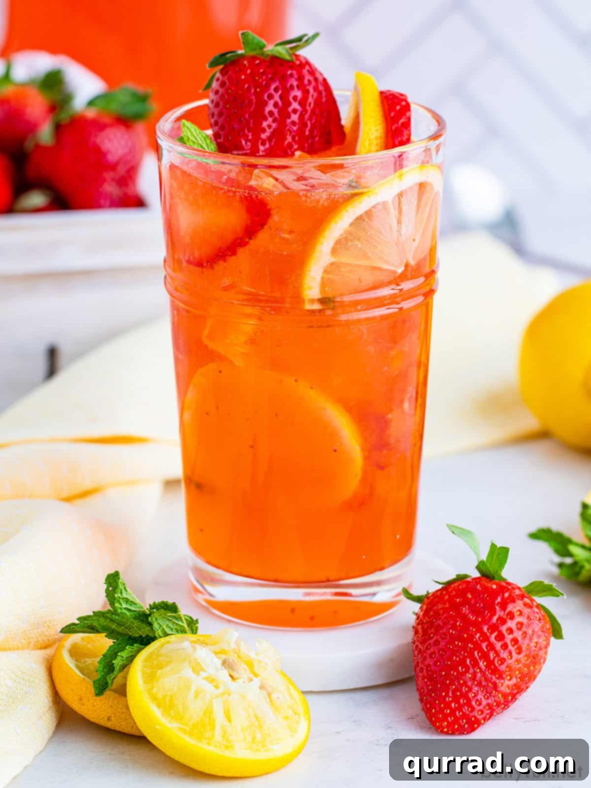 Vibrant Strawberry Lemonade 2 A vibrant glass of homemade strawberry lemonade adorned with fresh lemon slices and ripe strawberries, embodying the perfect sweet and tart summer beverage.