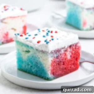 Festive Flag Poke Cake 3 A slice of red white blue poke cake on a white plate