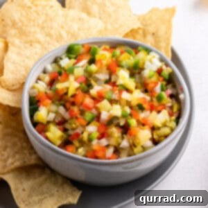 A vibrant bowl of Pickle de Gallo, brimming with diced pickles, onions, and peppers, ready for dipping.