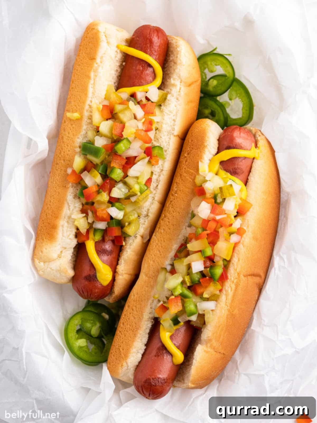 Dill Pickle de Gallo 5 Two grilled hot dogs generously topped with chunky, homemade Pickle de Gallo relish, ready to be enjoyed.