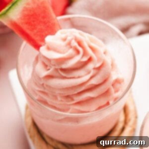 A close-up of a serving of watermelon dole whip in a small bowl.