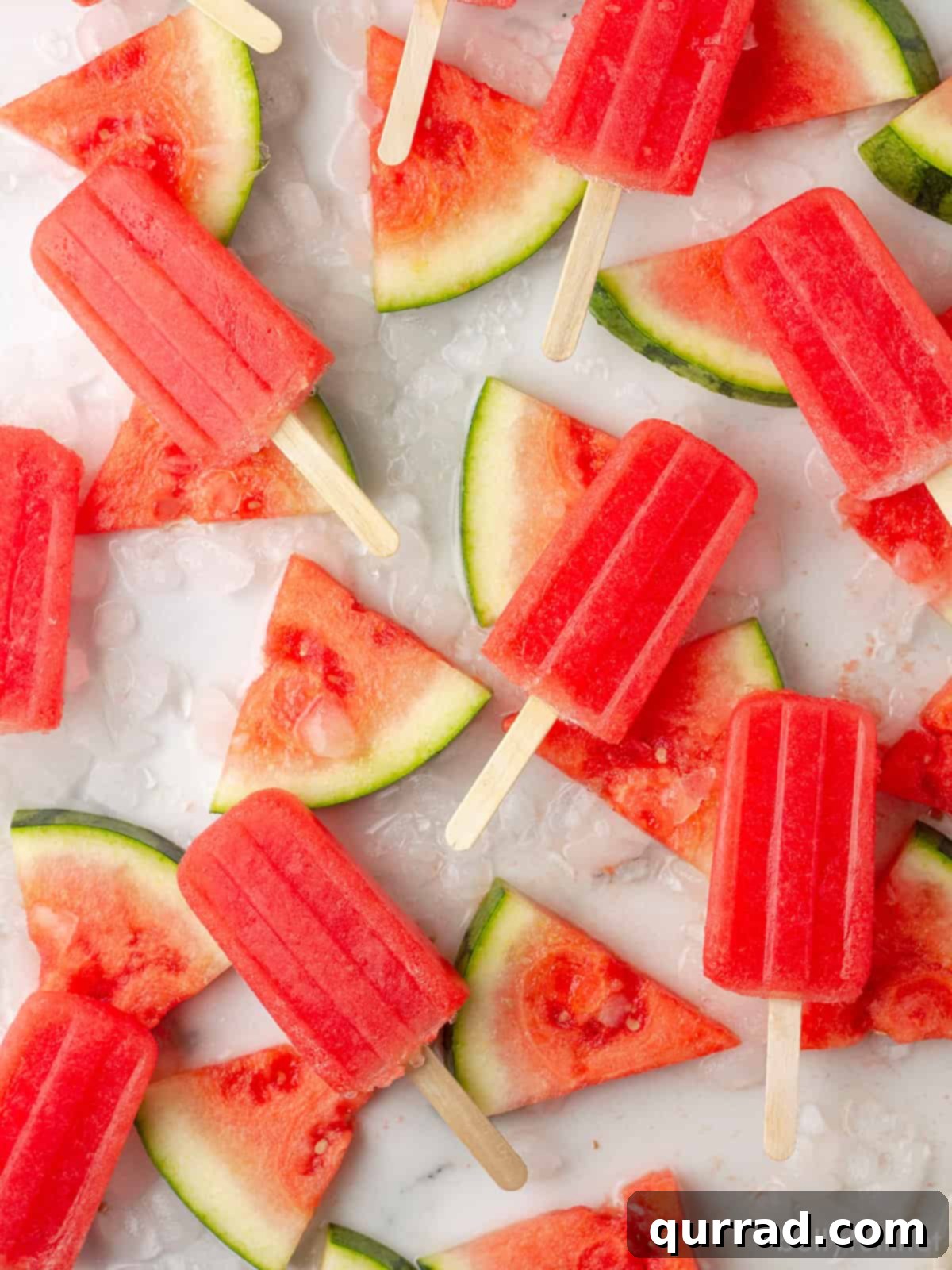 Refreshing Watermelon Ice Pops 4 Delicious and refreshing watermelon popsicles beautifully arranged on a bed of ice and fresh watermelon slices, perfect for summer.