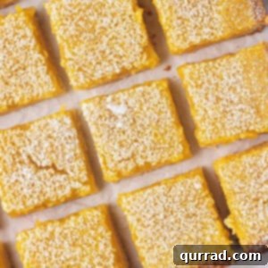 overhead close up cut lemon bar squares on parchment paper