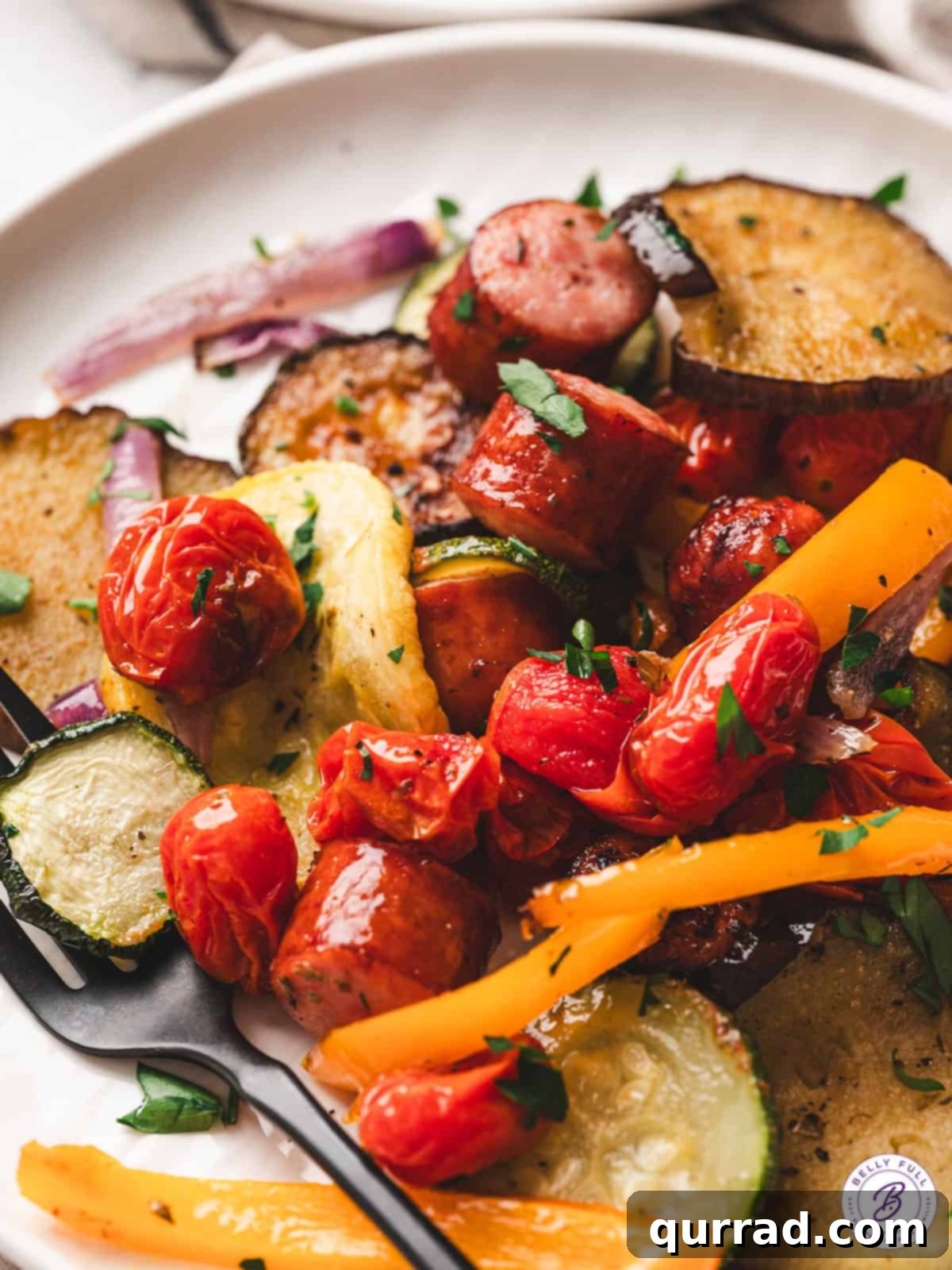 A plate of sheet pan ratatouille garnished with fresh parsley