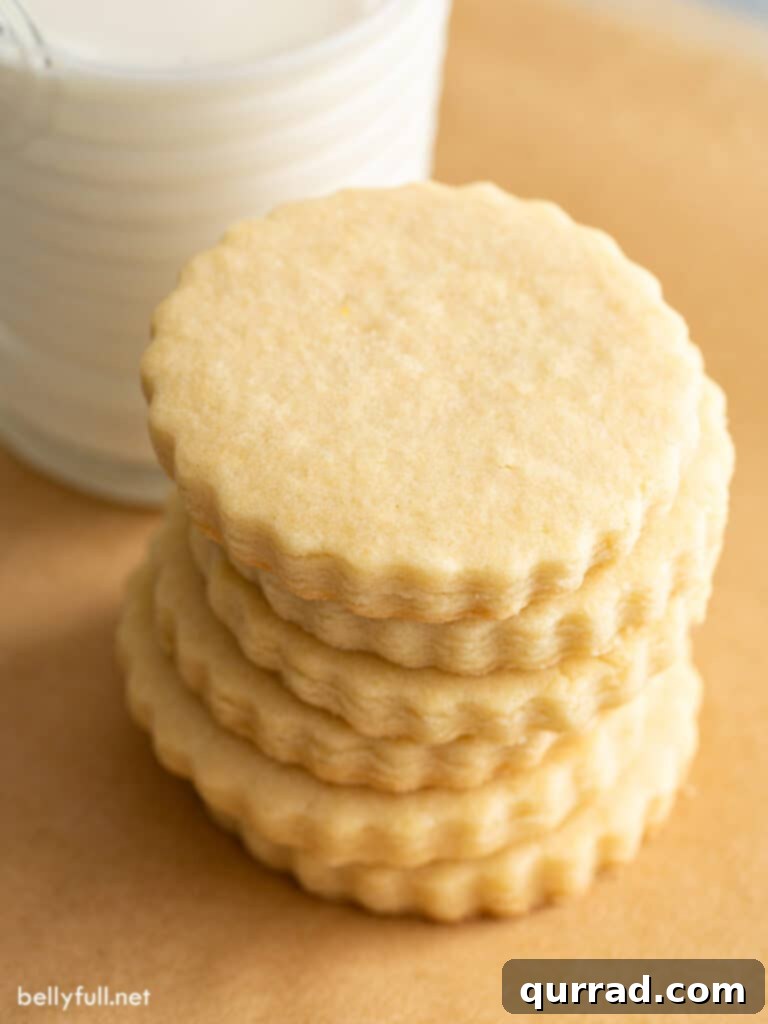Stack of perfectly baked, plain cut-out sugar cookies ready for decoration