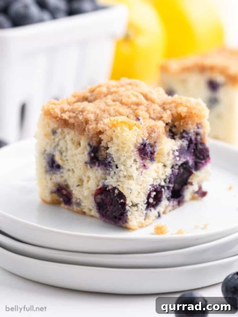 square slice of blueberry buckle cake on white plate