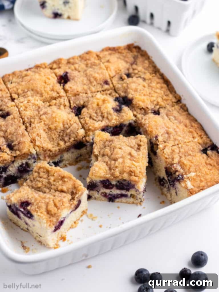 blueberry coffee cake slices in white baking dish