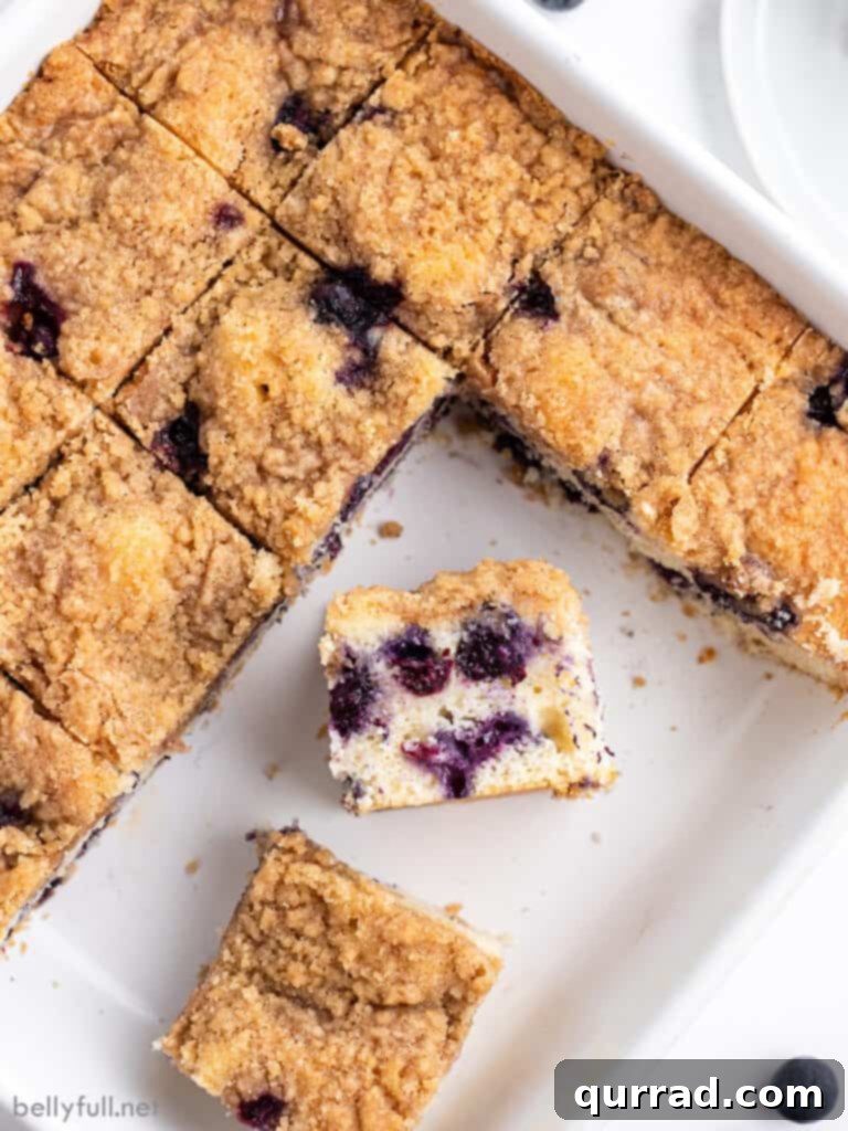 slice of blueberry buckle cake in baking dish