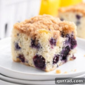 square piece of blueberry buckle cake on white plate