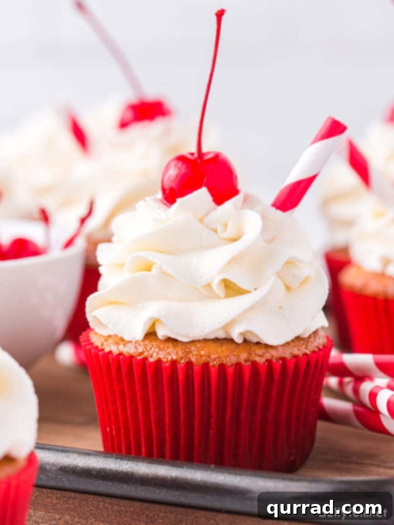 Frothy Root Beer Float Cupcakes 2 root beer float cupcakes with vanilla frosting and a Maraschino cherry on top