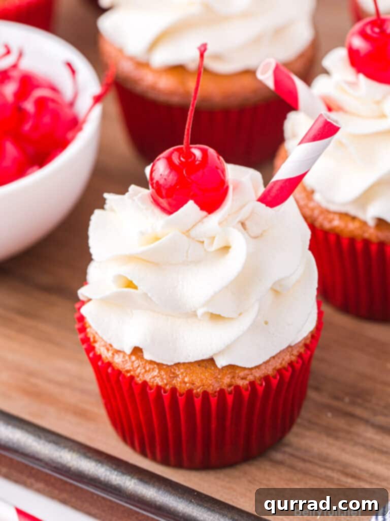 Frothy Root Beer Float Cupcakes 3 Cupcakes with vanilla frosting and a Maraschino cherry on top