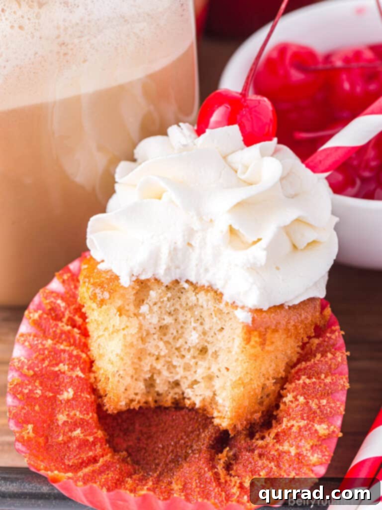 Frothy Root Beer Float Cupcakes 4 bite taken out of cupcakes with vanilla frosting