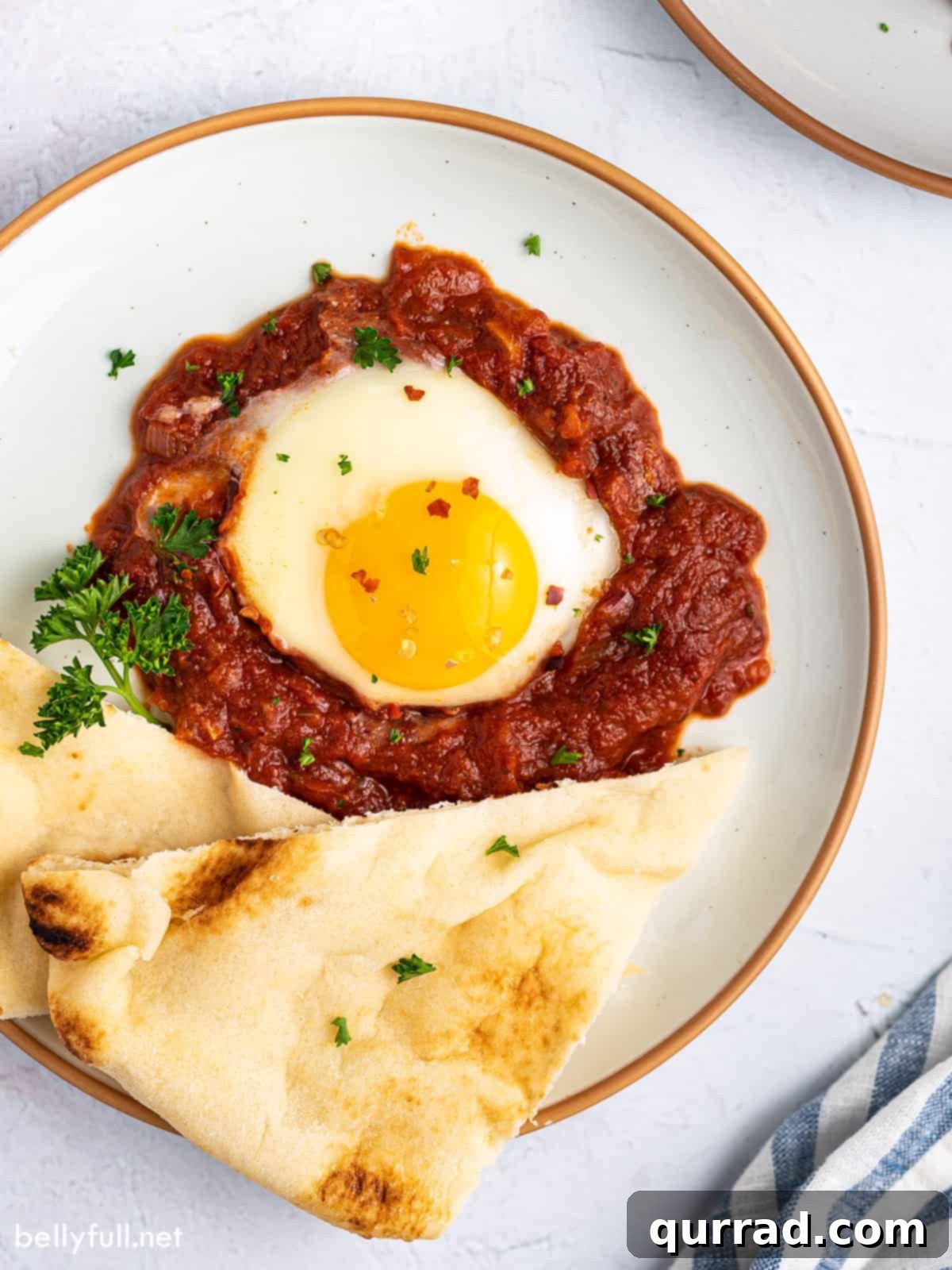 Inferno Baked Eggs 2 A poached egg in tomato sauce served with pita bread
