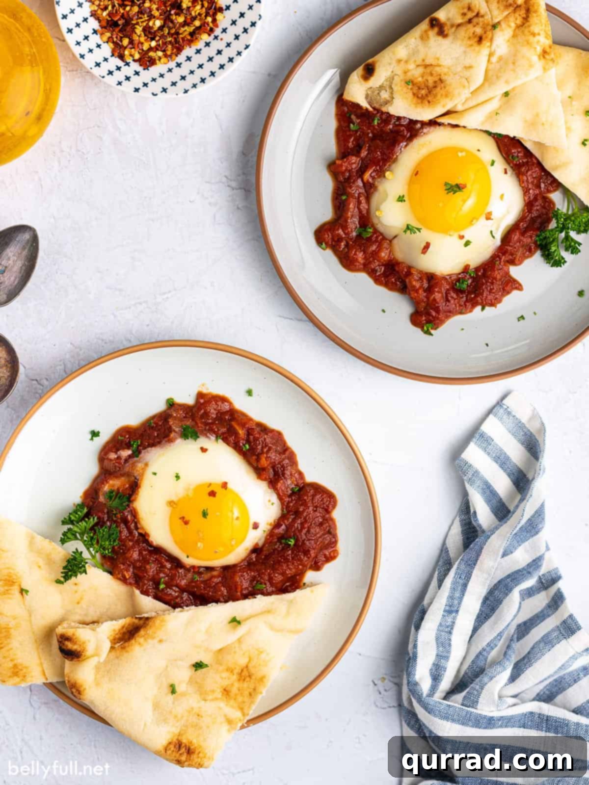 Inferno Baked Eggs 4 Two plates of eggs in purgatory with pita bread