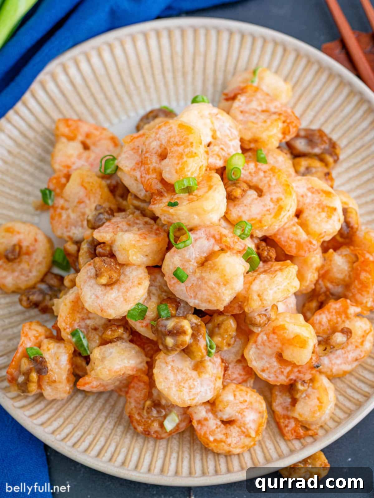 Crispy Honey Walnut Shrimp 5 A beautifully plated dish of honey walnut shrimp, topped with vibrant green scallions, ready to be enjoyed.