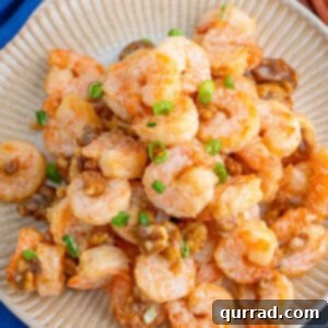 Crispy Honey Walnut Shrimp 6 A plate of honey walnut shrimp topped with scallions