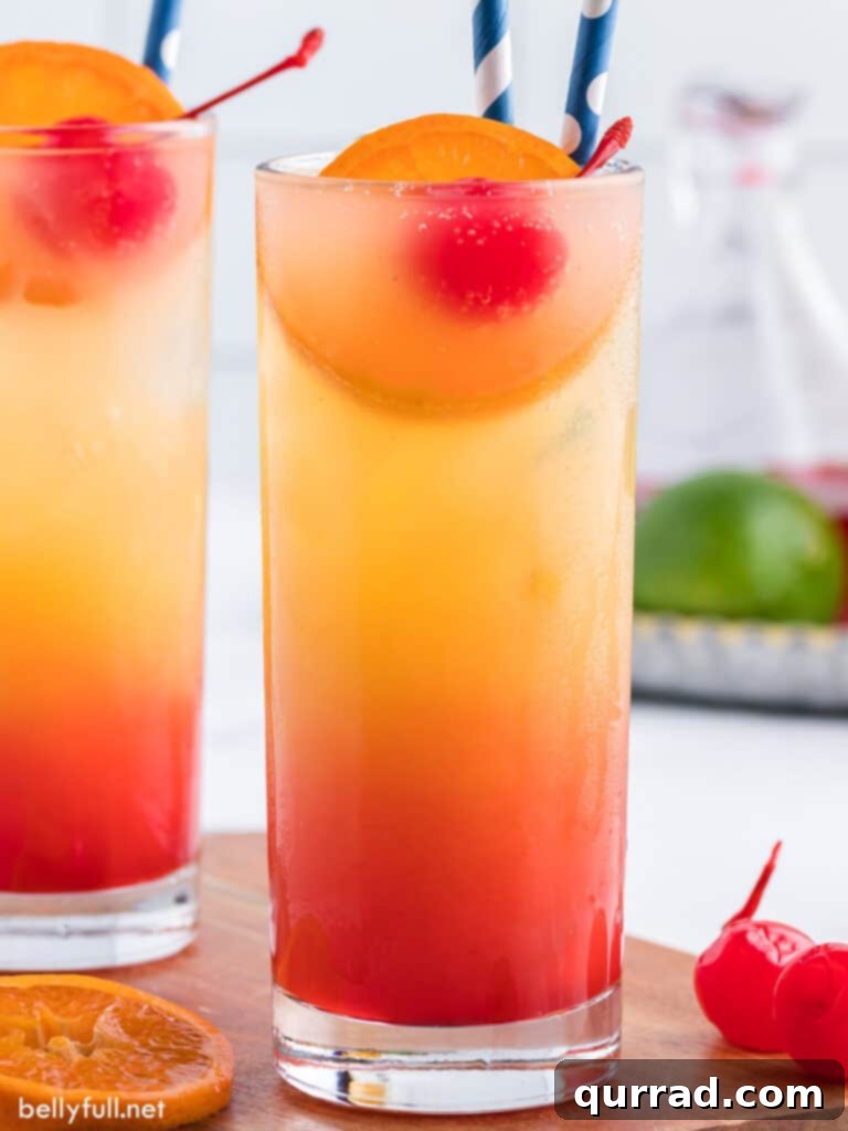 Dawn's Golden Kiss 3 Close-up of a layered Tequila Sunrise drink with tequila, orange juice, and Grenadine