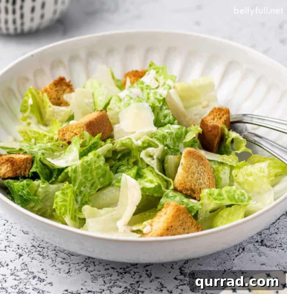 Imperial Romaine Delight 5 romaine salad with croutons and shaved Parmesan in white bowl
